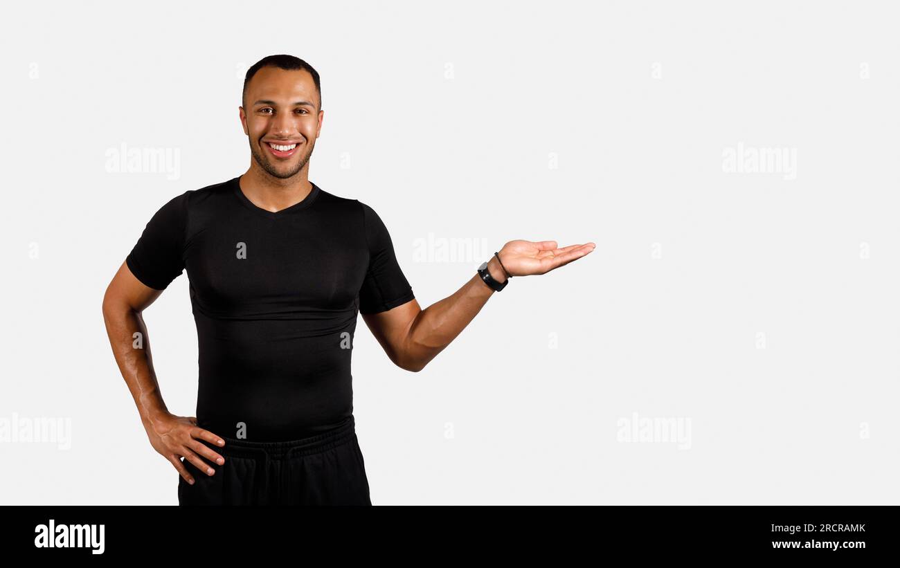 African Man In Fitwear Showing Empty Space On White Background Stock ...