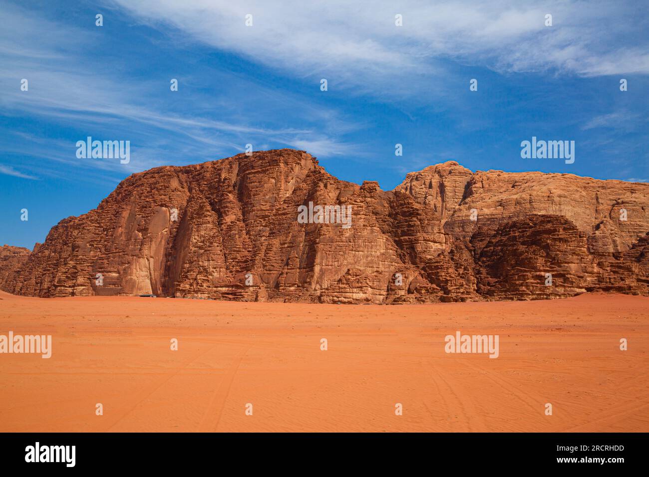 Wadi Rum desert in Jordan. Mountain, blue bright sky and red sands. Stock Photo