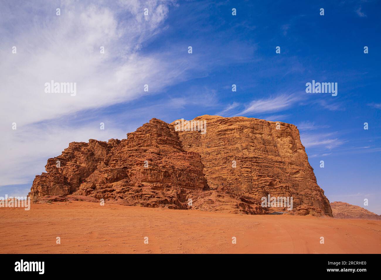 Wadi Rum desert in Jordan. Mountain, blue bright sky and red sands. Stock Photo