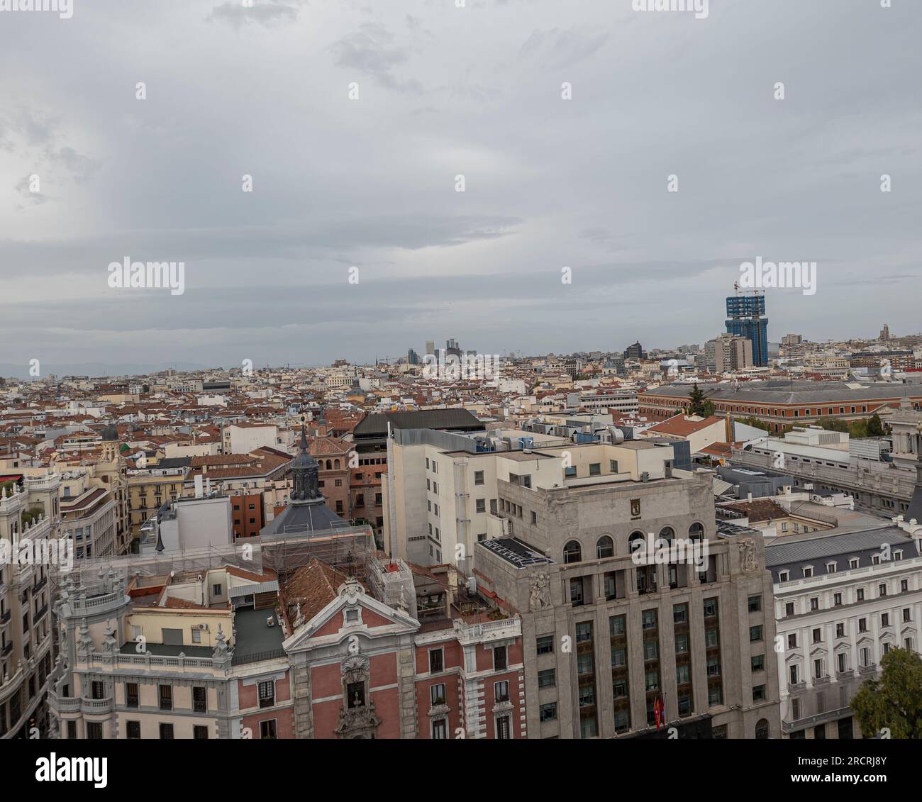 Unforgettable Panoramic Vantage: Glimpsing the Bustling Energy of Madrid's Gran Via from a Spectacular Rooftop Overlook Stock Photo