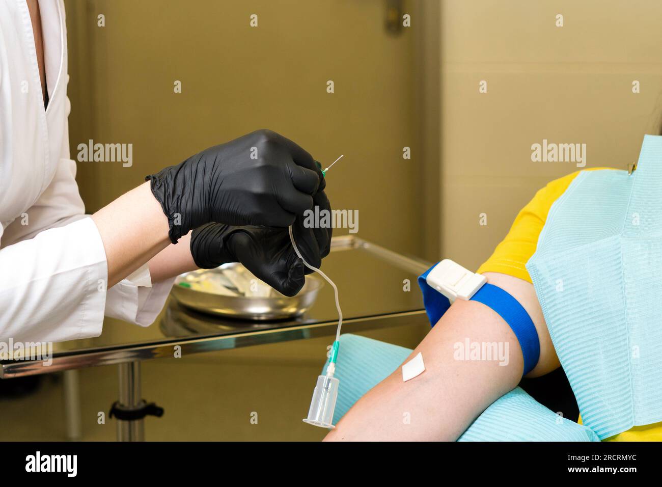 Preparing for blood test. Nurse uses butterfly needle to take patient's ...