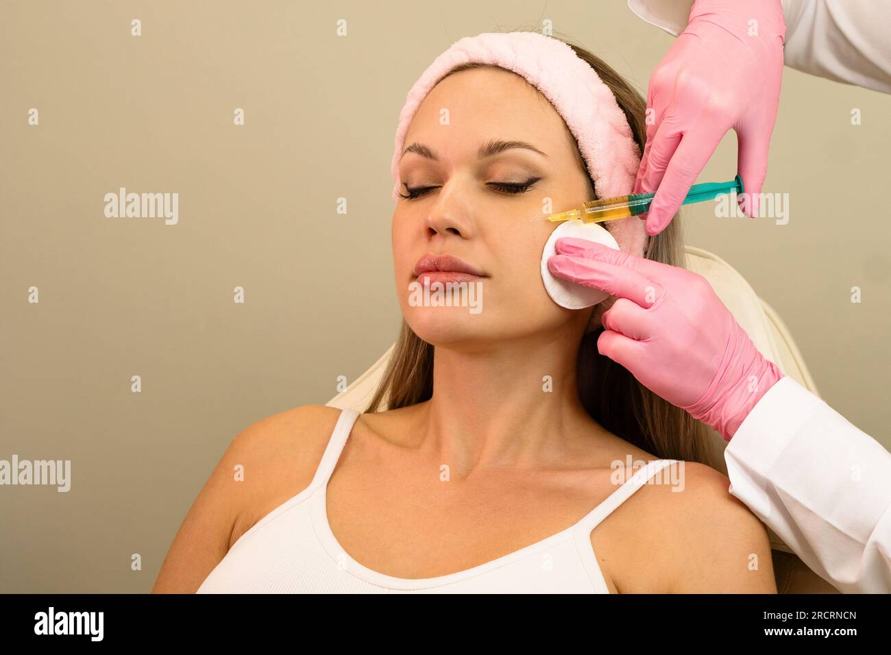 Сosmetologist uses thin needle to inject PlateletRich Plasma in skin