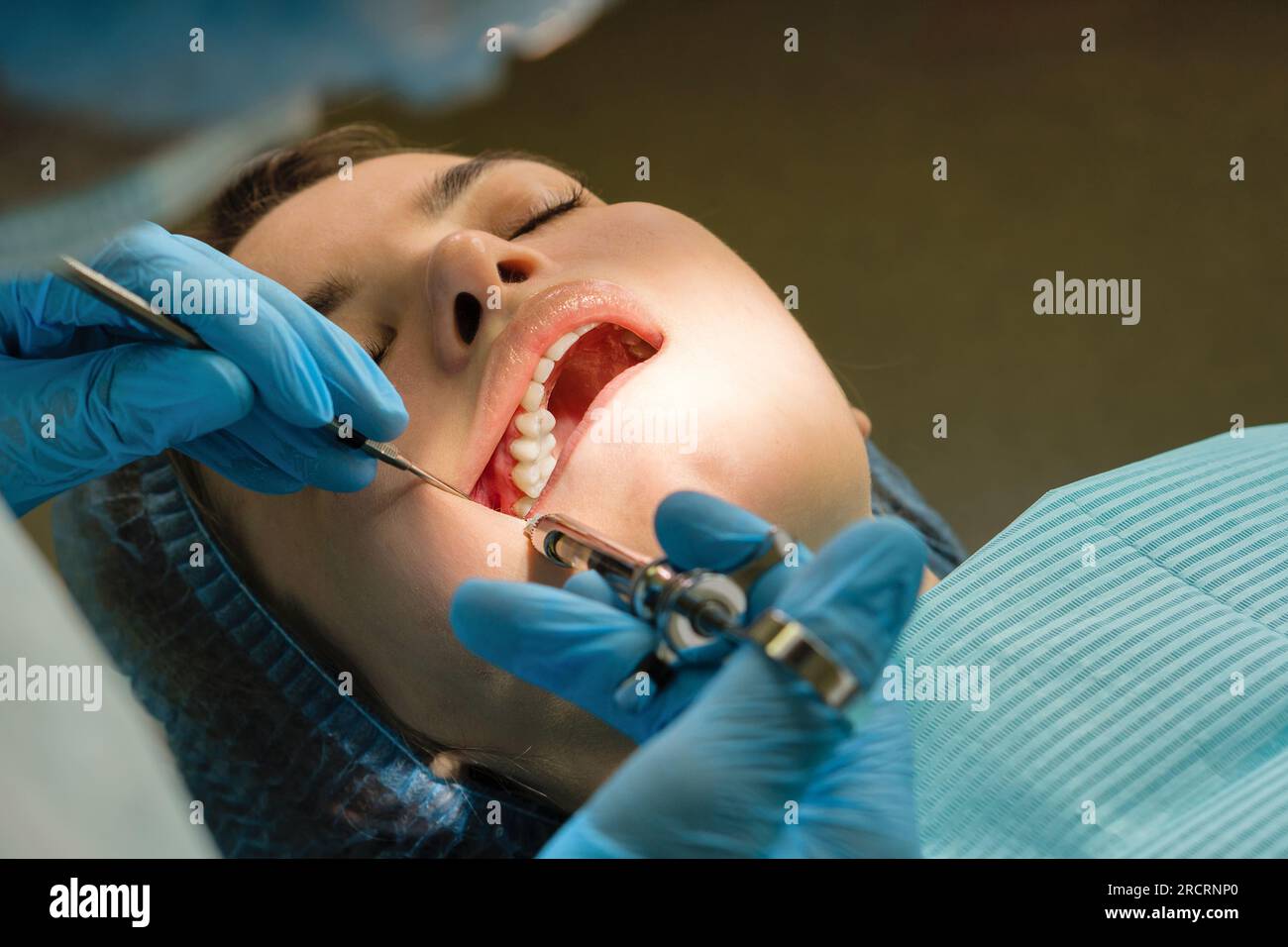 Dental surgeon performs conduction anesthesia with lidocaine using a