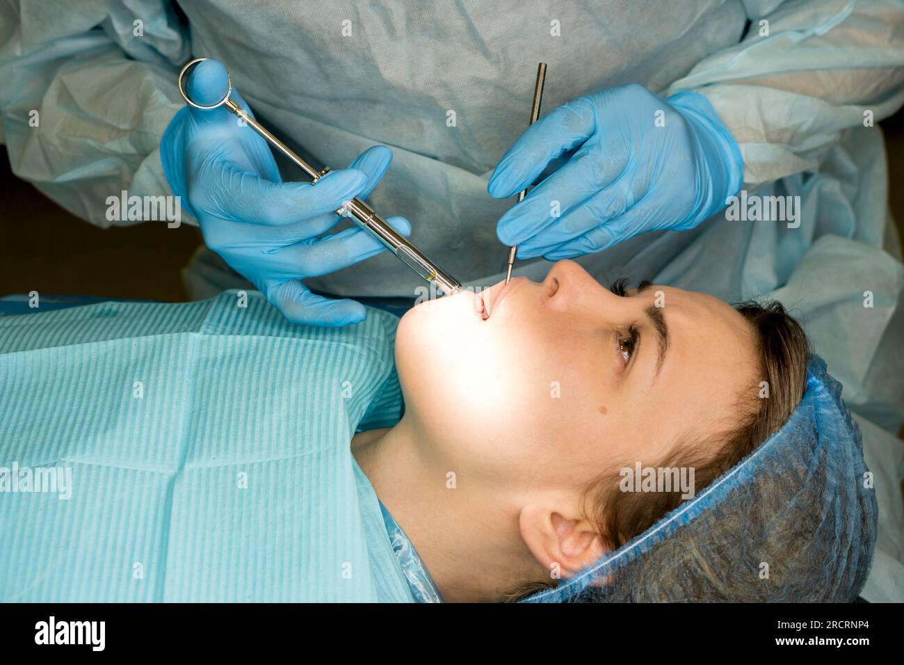 Dental surgeon performs conduction anesthesia with lidocaine using a