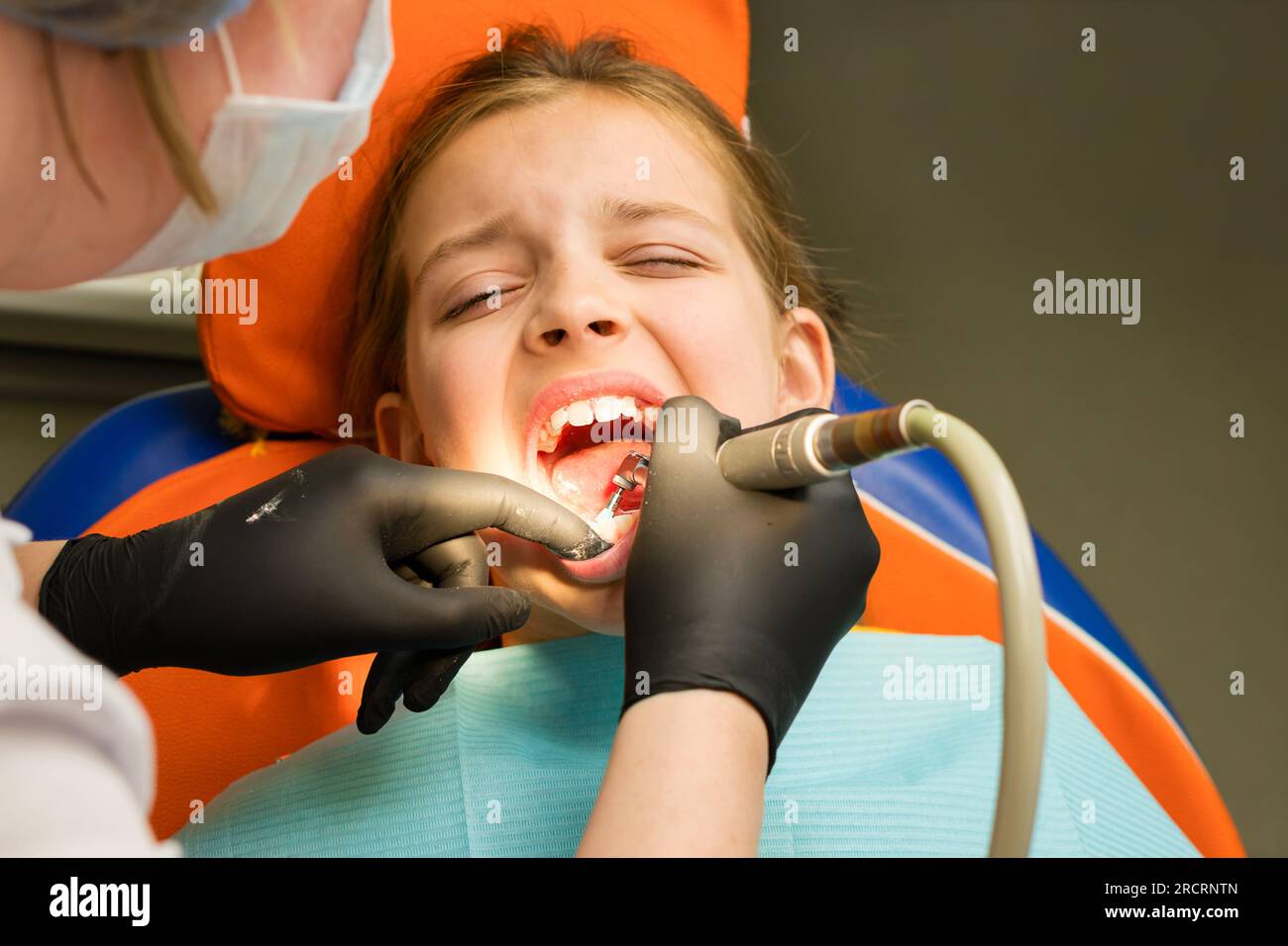 Girl on dental appointment. Professional oral hygiene. Atraumatic