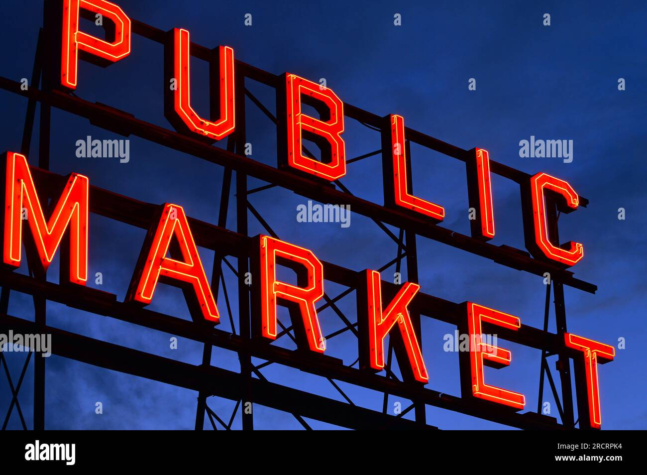 The sign for the Public Market at Pike Place Market in Seattle is illuminated at night Stock Photo