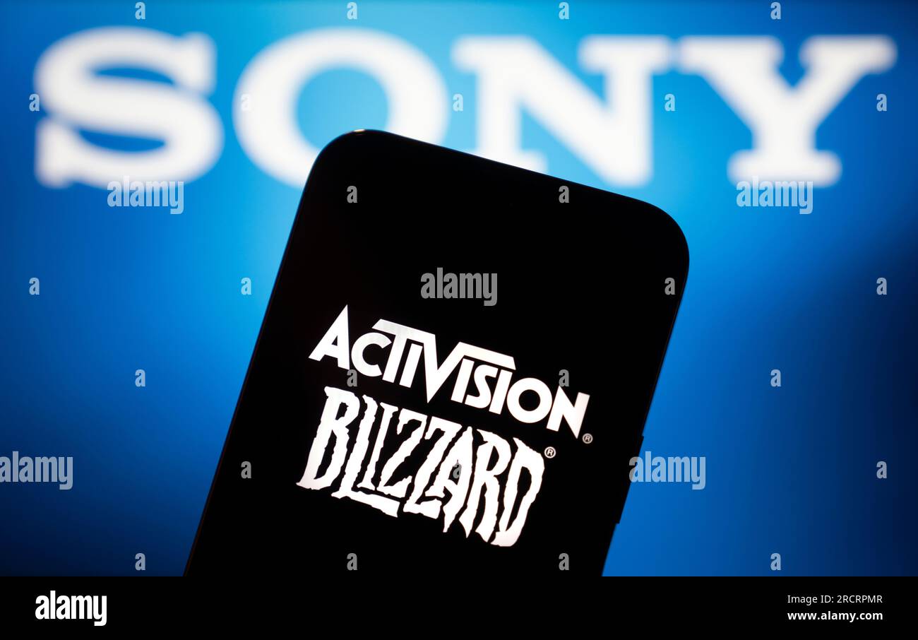 The Sony logo is seen in the background with the Activision Blizzard logo on a mobile device in this photo illustration on 14 July, 2023. Stock Photo