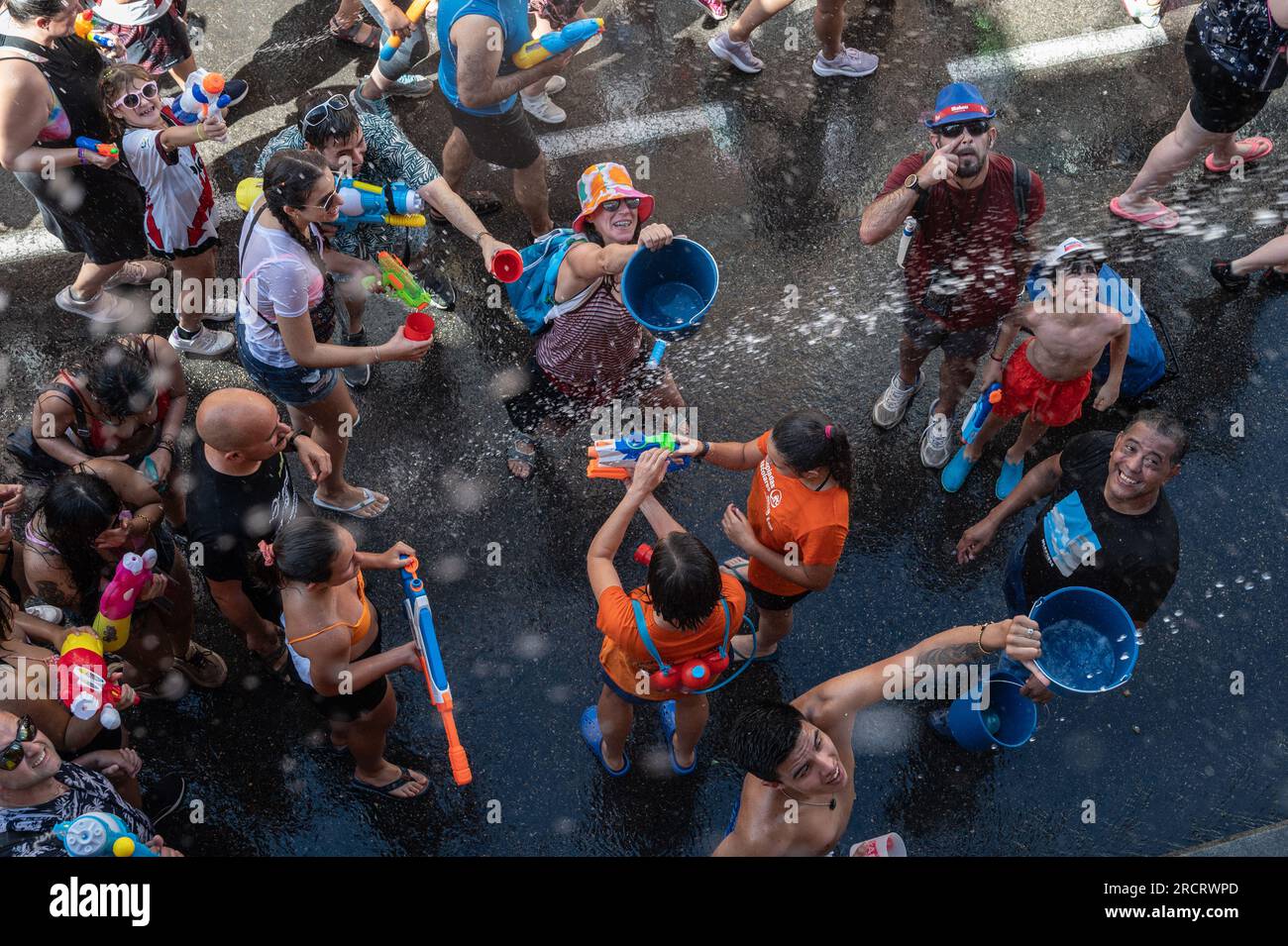 Madrid, Spain. 16th July, 2023. Revelers take part in the annual summer water fight celebrated in the neighborhood of Vallecas. Many thousands of people have participated in the water fight known as 'Batalla Naval' (Naval battle) this year coinciding with a heatwave. Credit: Marcos del Mazo/Alamy Live News Stock Photo