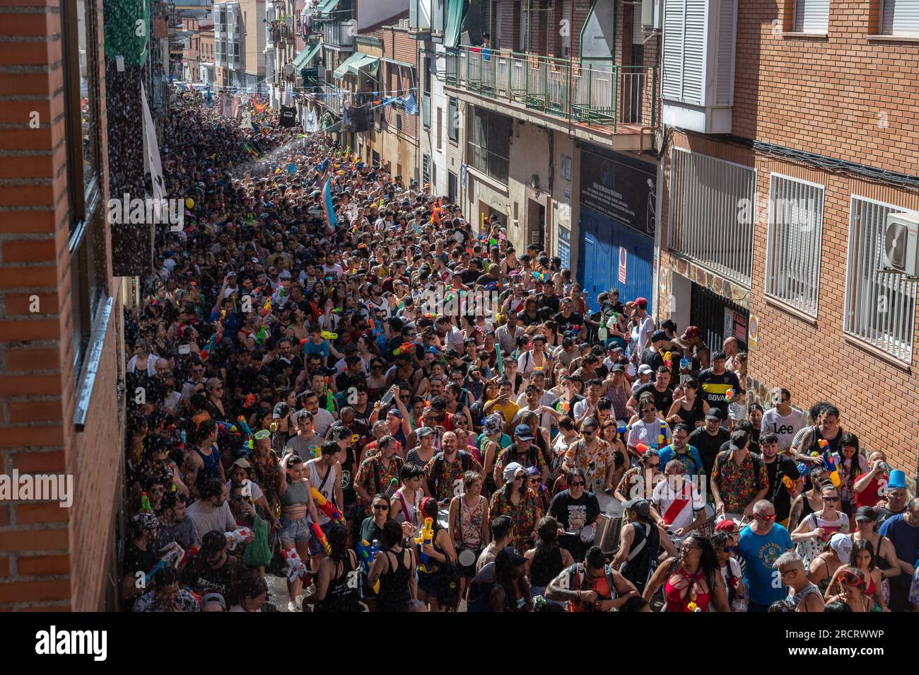 Madrid, Spain. 16th July, 2023. Revelers take part in the annual summer water fight celebrated in the neighborhood of Vallecas. Many thousands of people have participated in the water fight known as 'Batalla Naval' (Naval battle) this year coinciding with a heatwave. Credit: Marcos del Mazo/Alamy Live News Stock Photo