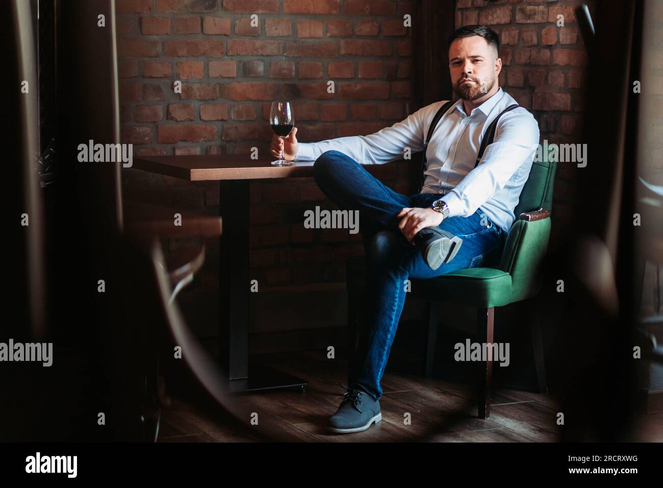 Handsome young man enjoying a glass of red wine Stock Photo