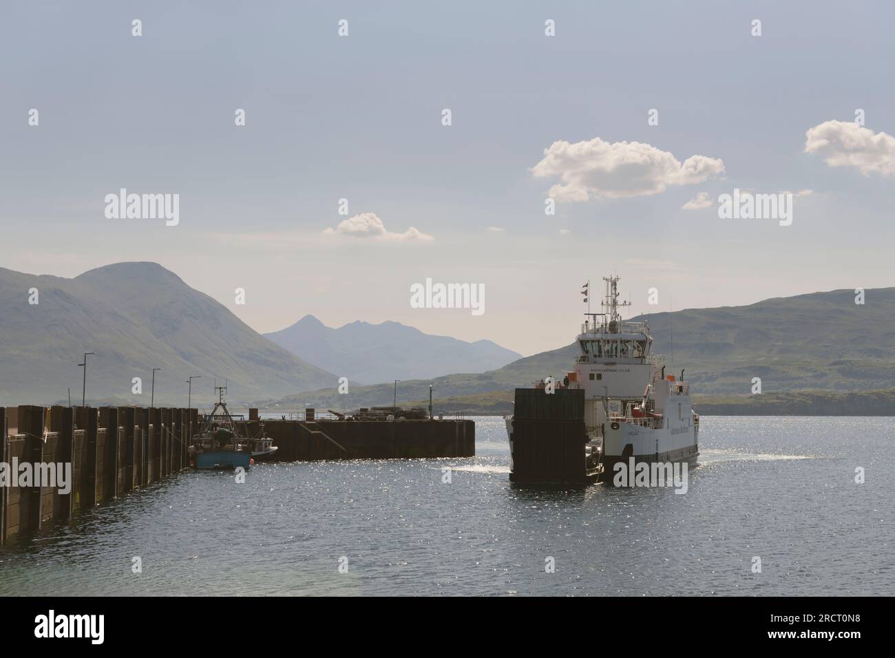 The CalMac Car Ferry from Sconser on the Isle of Skye Approaching the Jetty on Raasay in Summer with Views to Glamaig and the Red Cuillins Stock Photo