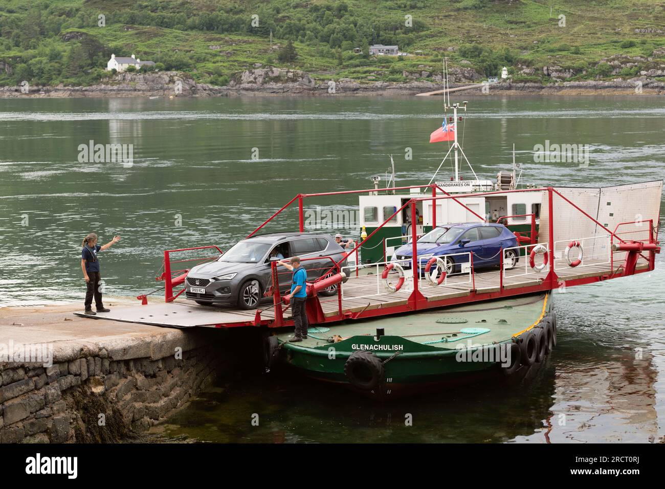 Under the Guidance of the Deckhands, Cars Disembark from the MV Glenachulish, a Manually Operated Turntable Ferry, at Kylerhea on the Isle of Skye. Stock Photo