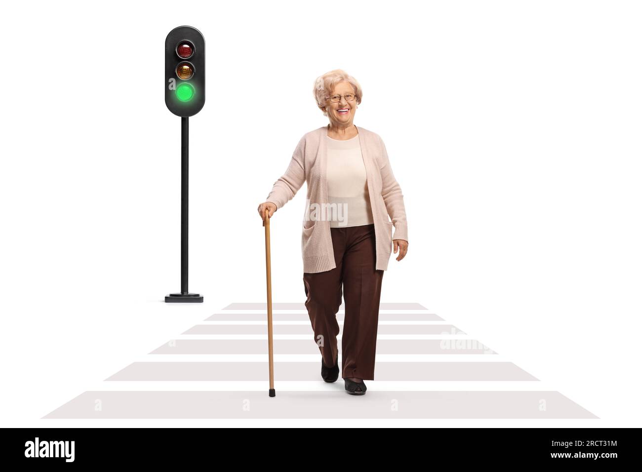 Full length portrait of an older lady crossing a street isolated on white background Stock Photo