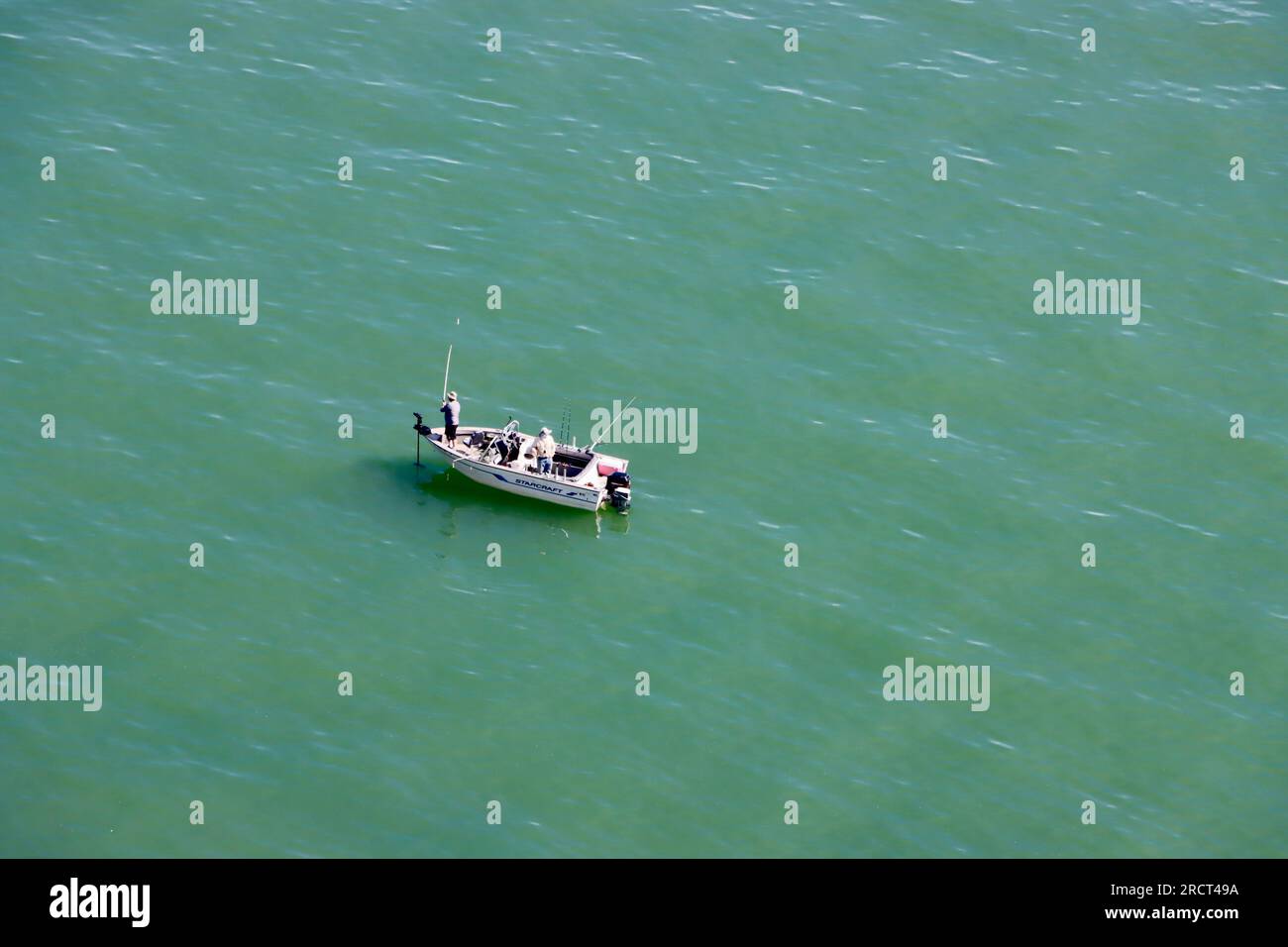 Fishing boat on green blue waters of Lake Erie.  Lakewood, Ohio, USA Stock Photo