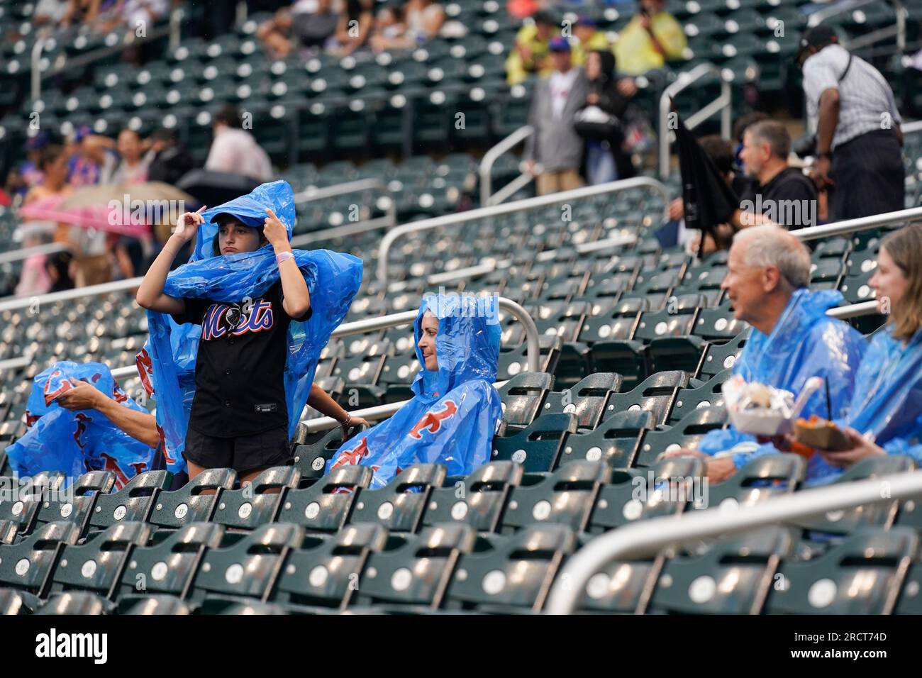 Fans wear rain ponchos before a baseball game between the New York