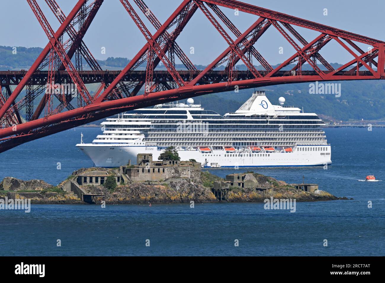 Cruise Ship MS Riviera Anchored In The Firth Of Forth Near To The Forth Rail Bridge & Inchgarvie Island. Stock Photo