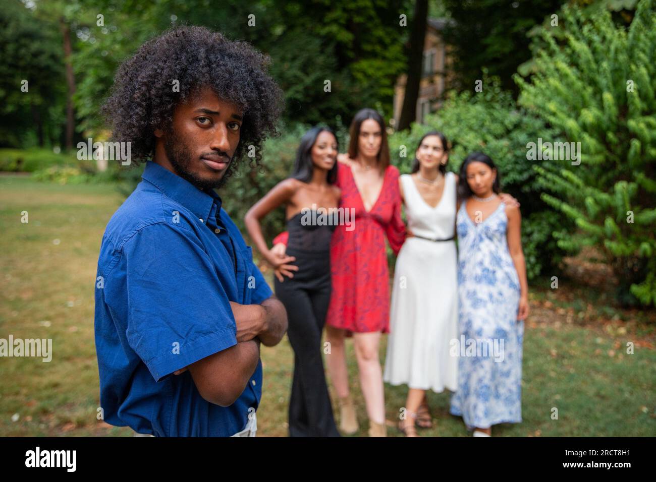Portrait of an African boy with 4 girls looking at him in the background, multi ethnic group Stock Photo