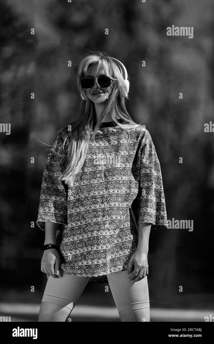 blonde athletic girl stands on the football field black and white Stock
