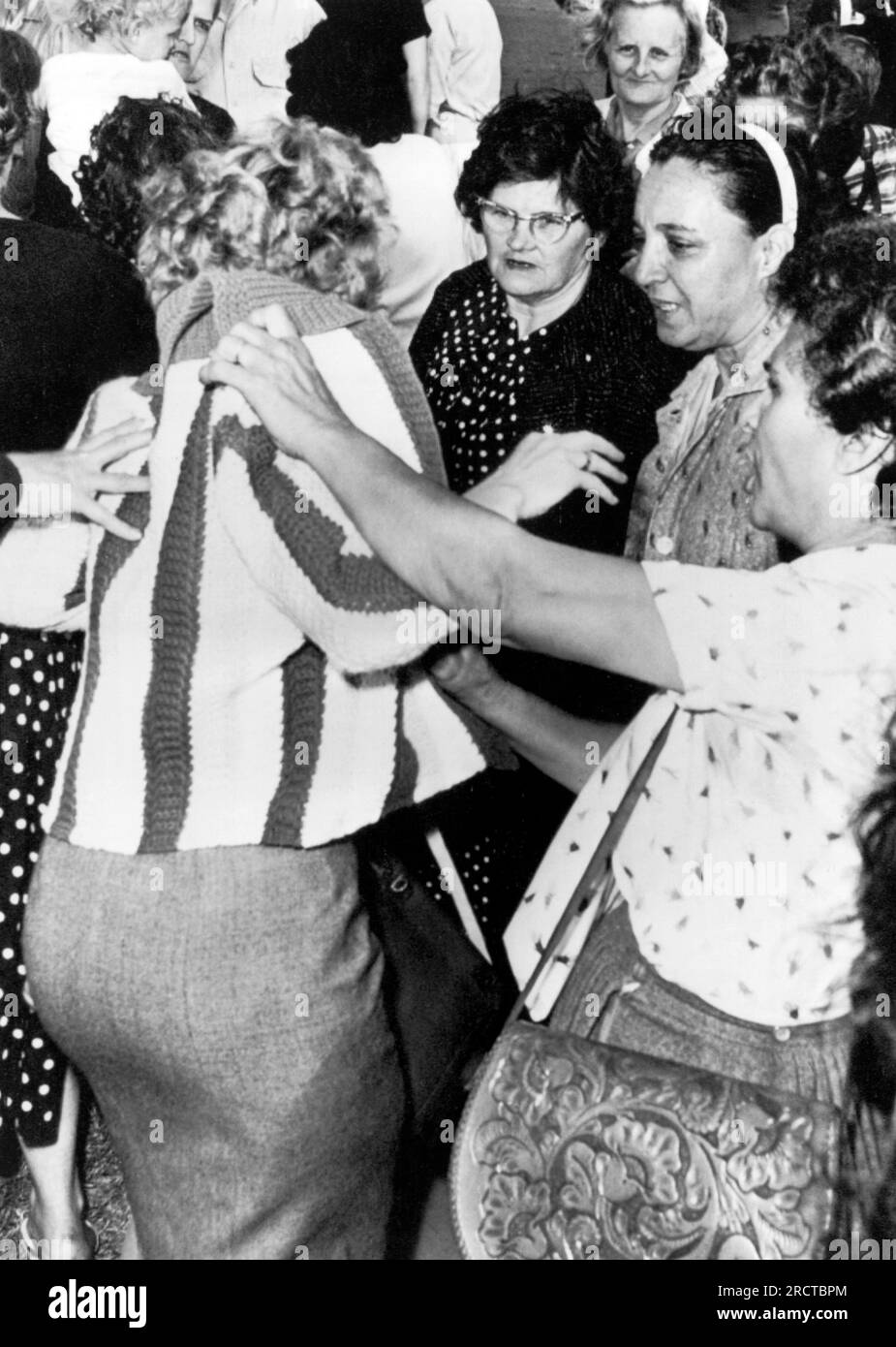 New Orleans, Louisiana:  December 6, 1960 Kirstin Steene, an English professor at the Univeristy of Alberta in Canada, is roughed up by local women demonstrators at the Frantz Elementary School as she was filming the first days of integraton at the school. Stock Photo