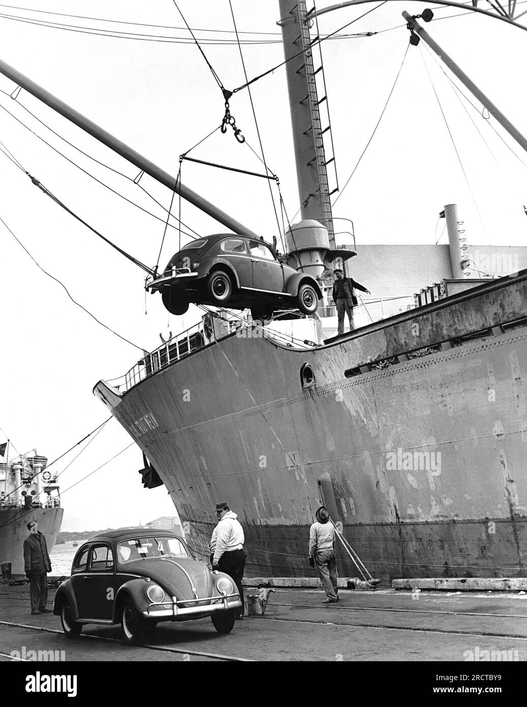 United States:  c. 1962 The auto carrier ship M.S. Carl Trautwein unloads its cargo of 1250 Volkswagons. A shipload like this arrives somewhere in the United States every day. Stock Photo