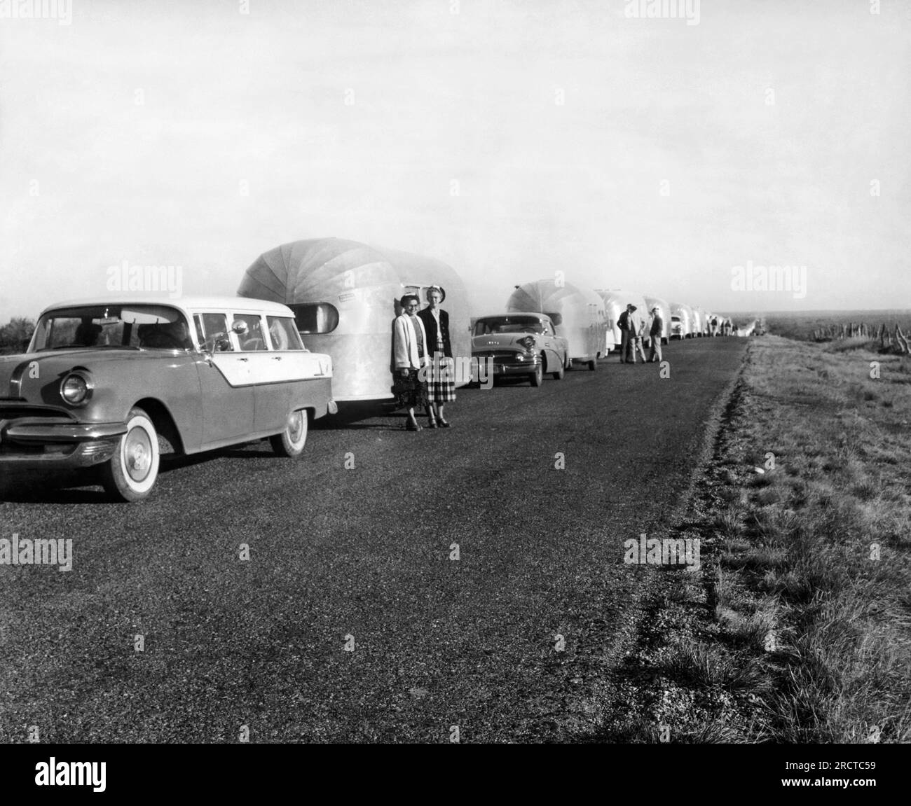 United States:  1956 A line of Airstream trailers as far as the eye can see parked on a country road. Stock Photo
