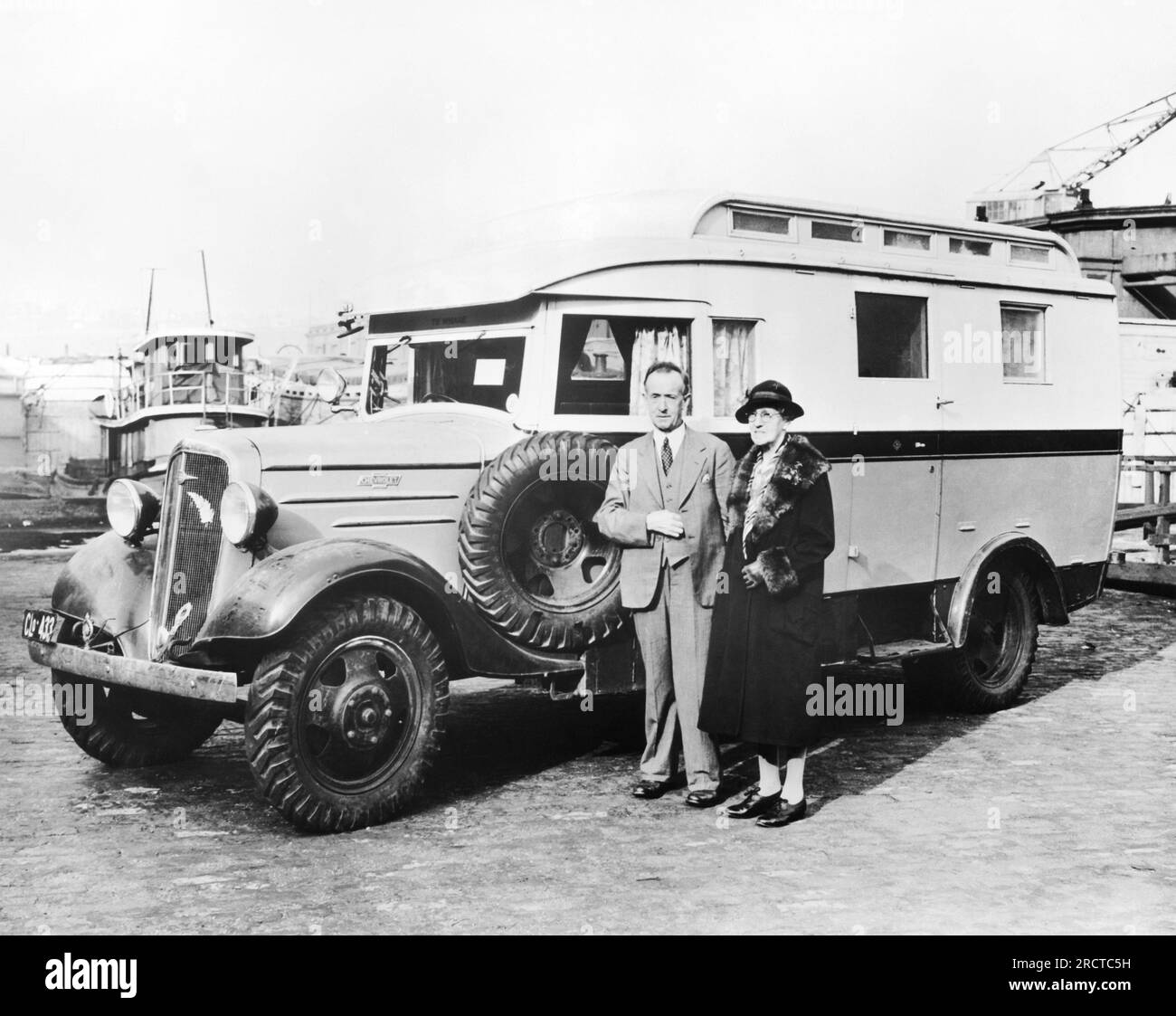New York, New York:   c. 1932 A couple arrives in New York city with their Chevrolet Truck motor home in which they have toured New Zealand, Africa and Australia, and are now ready to tour the United States. Stock Photo