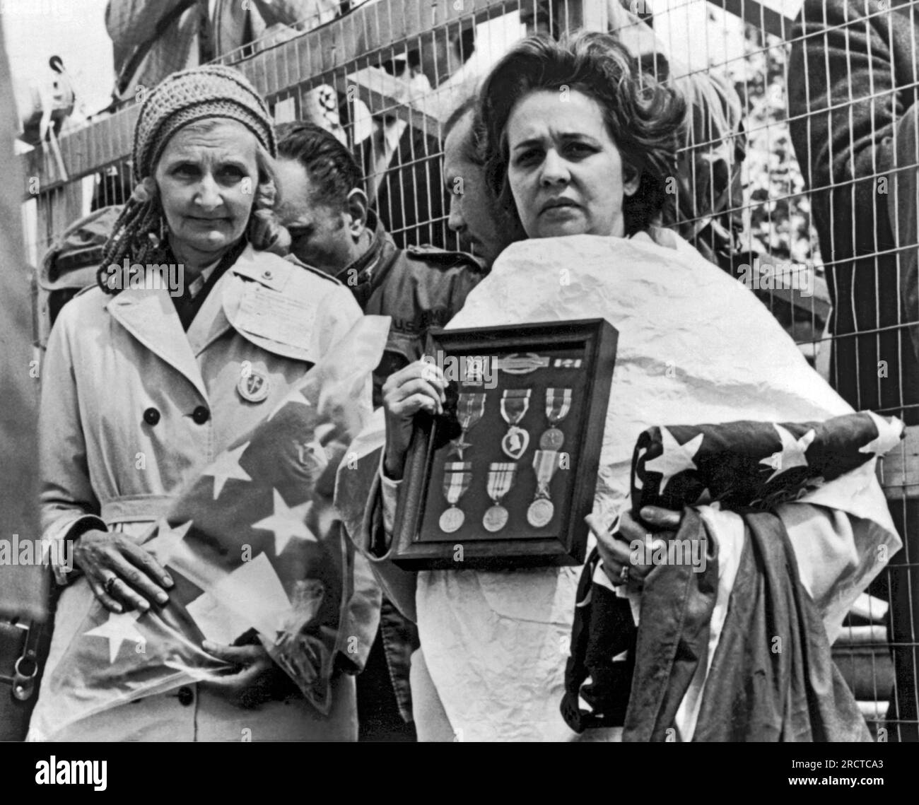 Washington, D.C.:  April 23, 1971 Two Gold Star mothers hold their dead sons' medals and flags at an anti Vietnam war protest near the Capitol today. They are Anna Pine (L) of Trenton, New Jersey and Evelyn Carrasquillo of Miami, Florida. Fred Pine and Alberto Carrasquillo were killed in Vietnam in 1968. Stock Photo