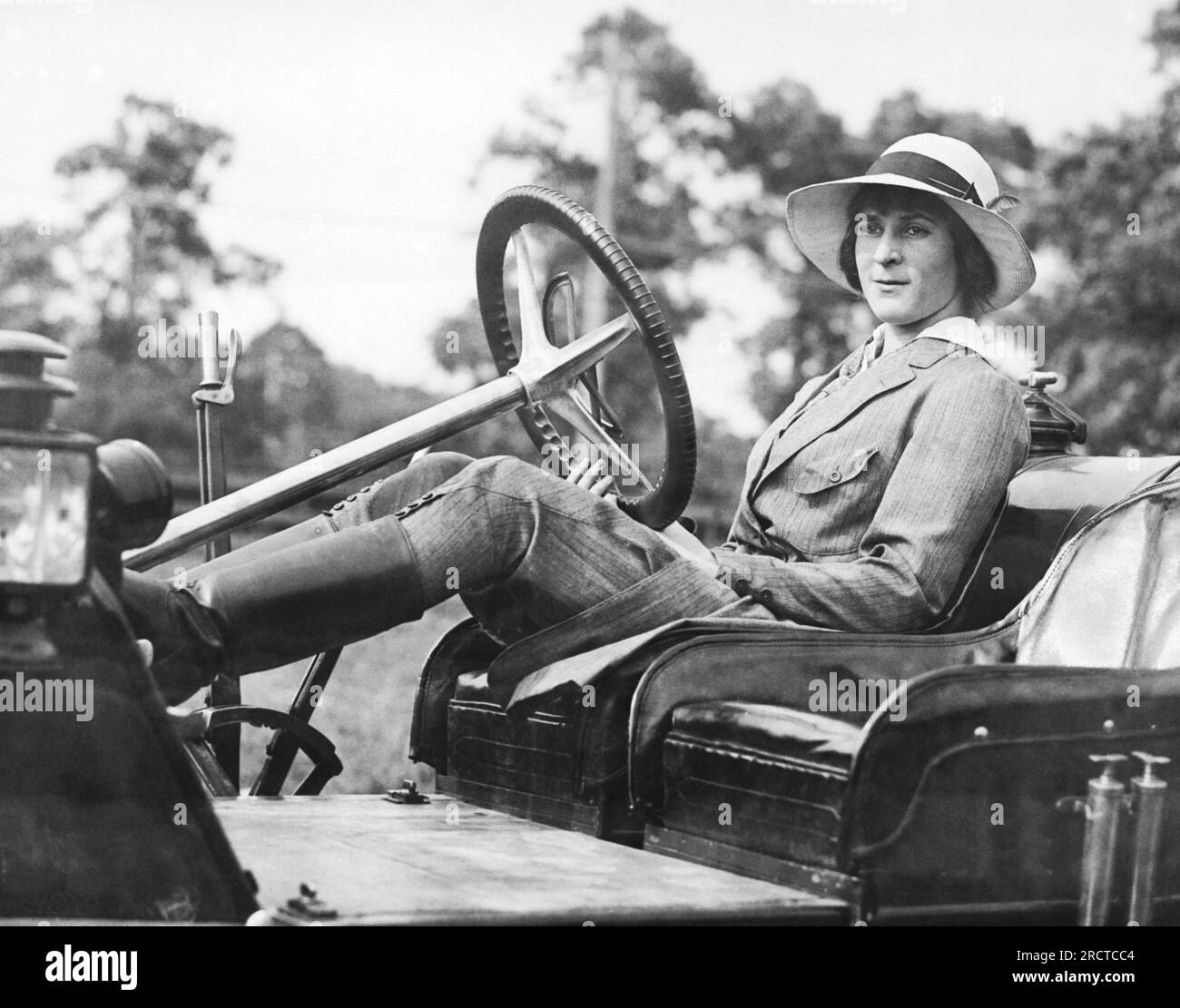 St. James, New York:  1911 Marion Gaynor, 14 year old daughter of New York Mayor William Jay Gaynor, sits at the wheel of her car at their Long island summer home. Stock Photo