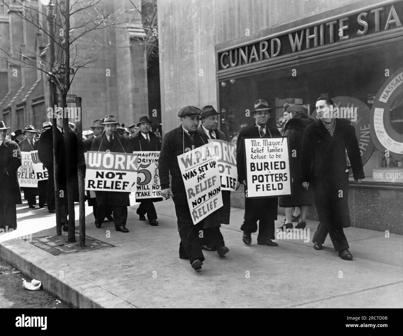 New York, New York:  April 9, 1939 WPA pickets marching along Fifth Avenue on Easter Sunday protesting Work Progress Administration policies. Stock Photo