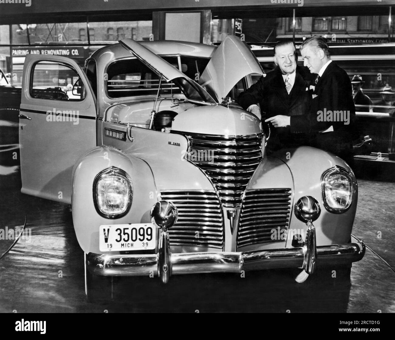New York, New York:  March, 1939 Chrysler De Soto executives preview the new 'Talking De Soto' in the International Salon of the Chrysler Building in NY. The specially engineered car does everything from blow its horn to stop and start its engine, all by itself with no one in the car. It is going on a nation-wide tour. Stock Photo