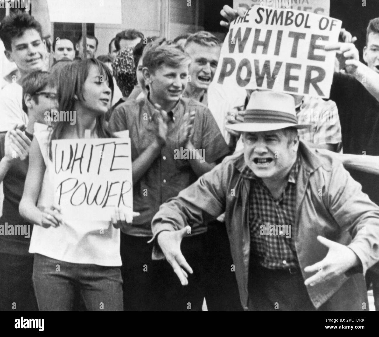Chicago, Illinois:   August 15, 1966 White power supporters gesture at civil rights marchers passing by in Gage Park. Stock Photo