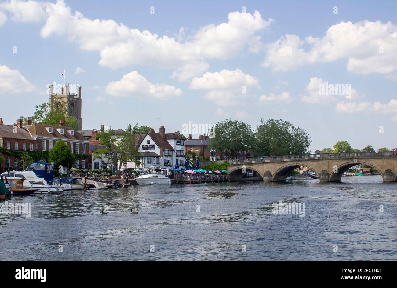 14 June 23 St Mary's Church of England tower overlooking the Thames with its boats and barges and river front properties in Thames at Henley-on-Thames Stock Photo