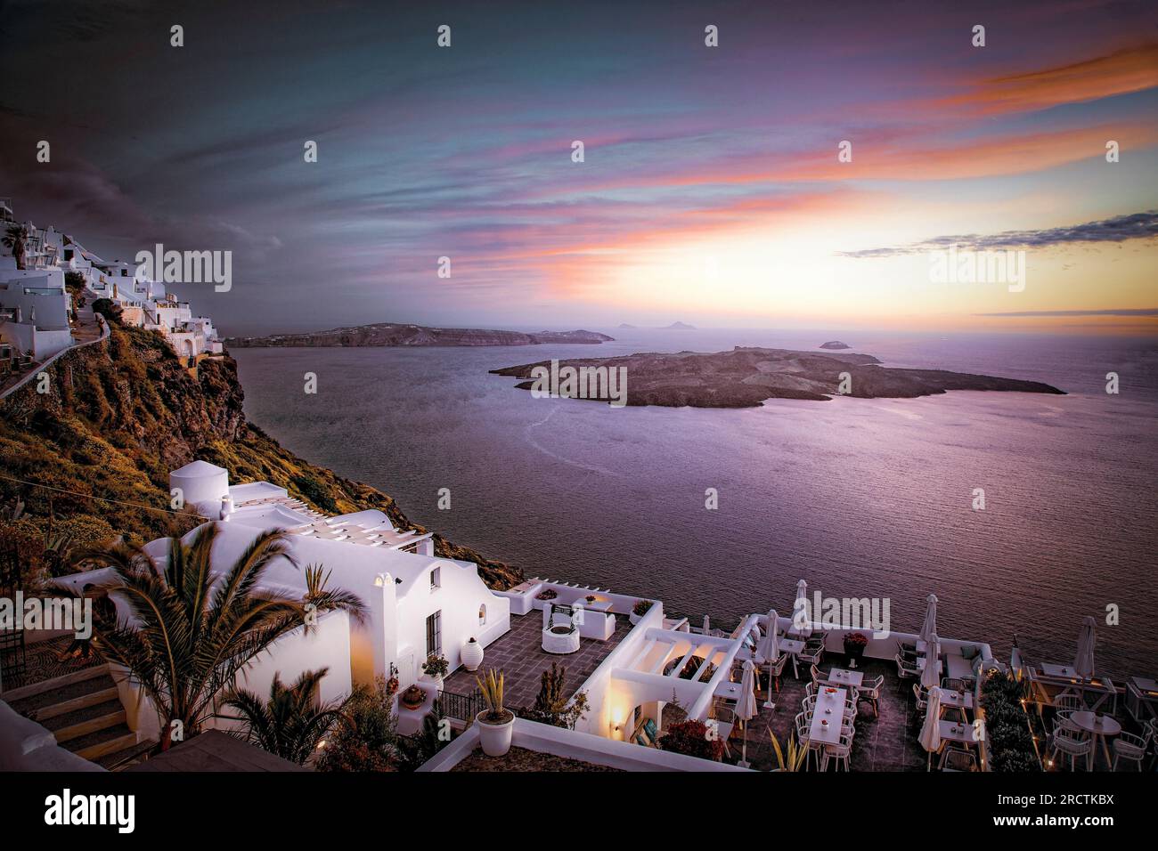 Hotels cascade down the caldera cliffs at Firostefani in Santorini, Greece. Stock Photo