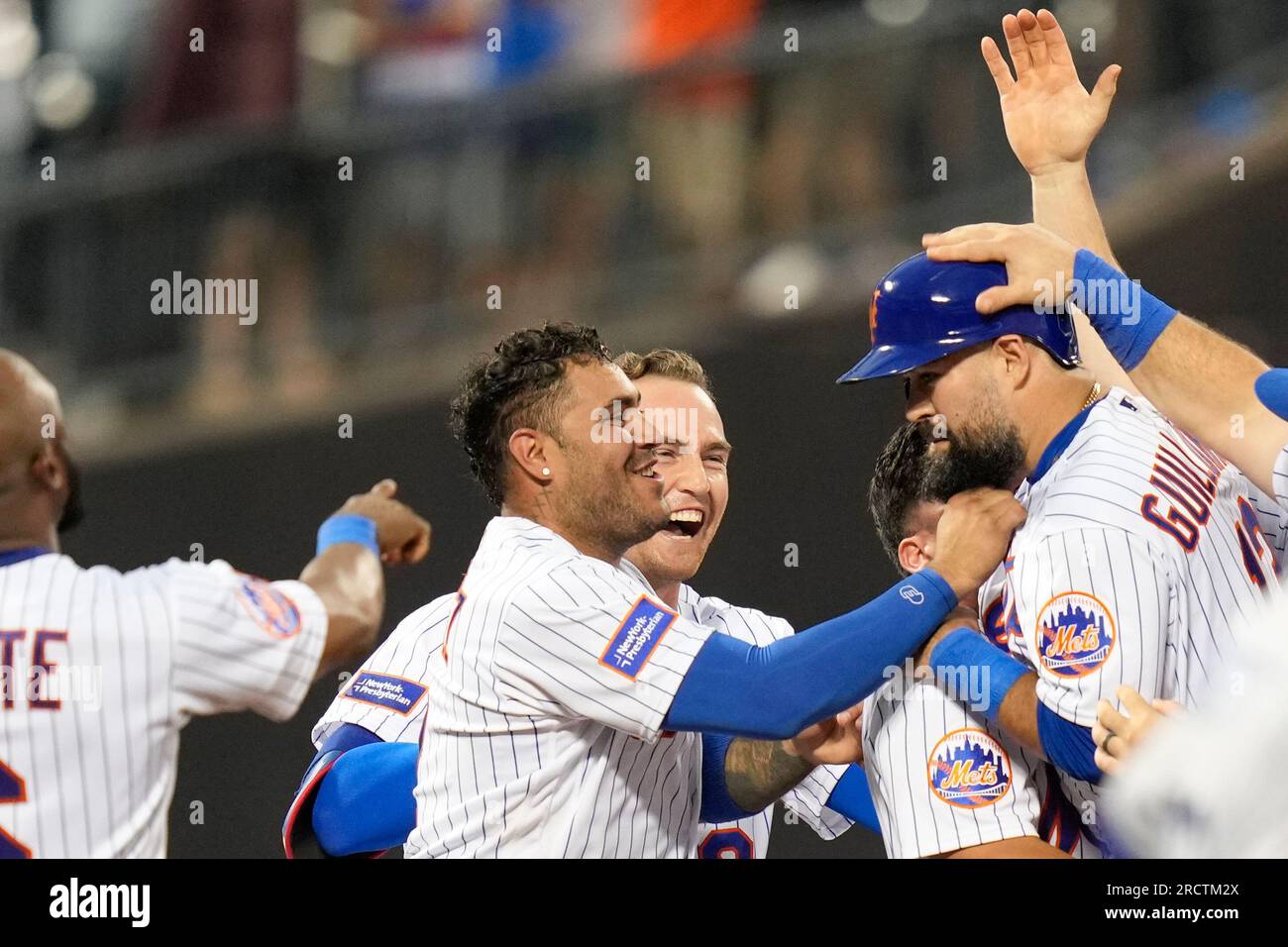 Teammates celebrate with New York Mets' Luis Guillorme, right, after he hit  a walk-off RBI single during the tenth inning of the baseball game against  the Los Angeles Dodgers at Citi Field