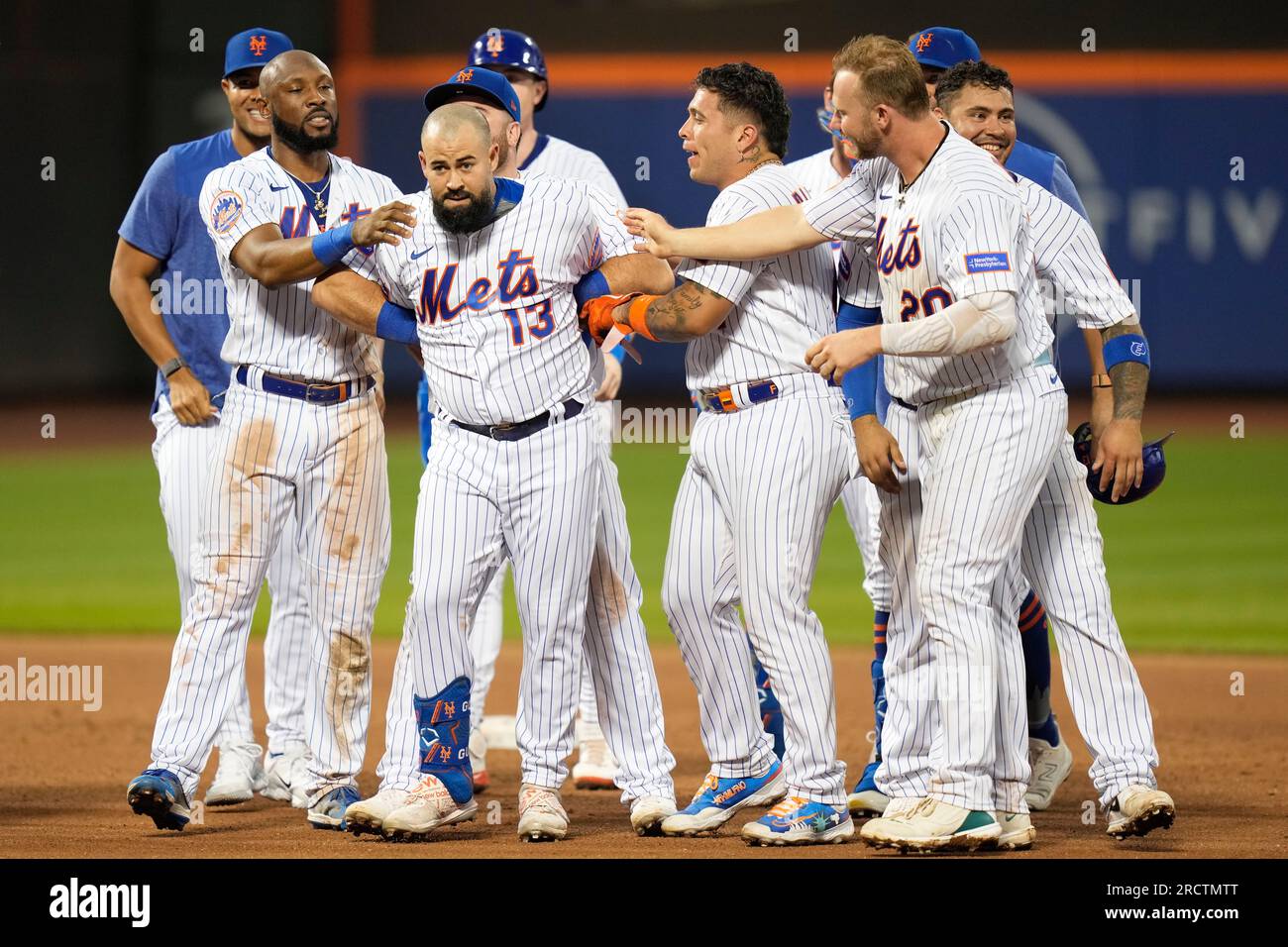 Teammates celebrate with New York Mets' Luis Guillorme (13) after