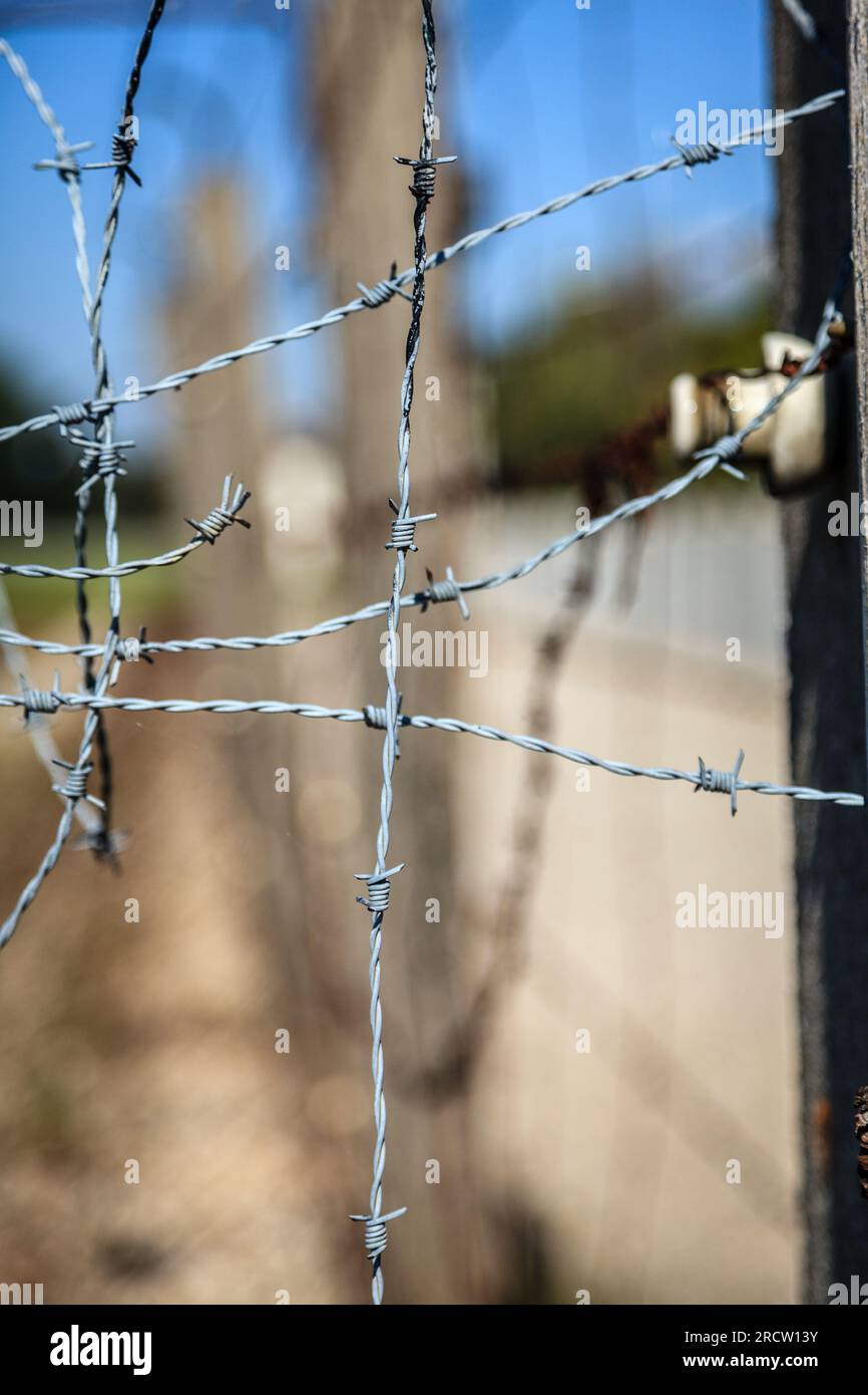 Close-up image of barbed wire of the perimeter fence at Dachau Concentration Camp in Germany Stock Photo