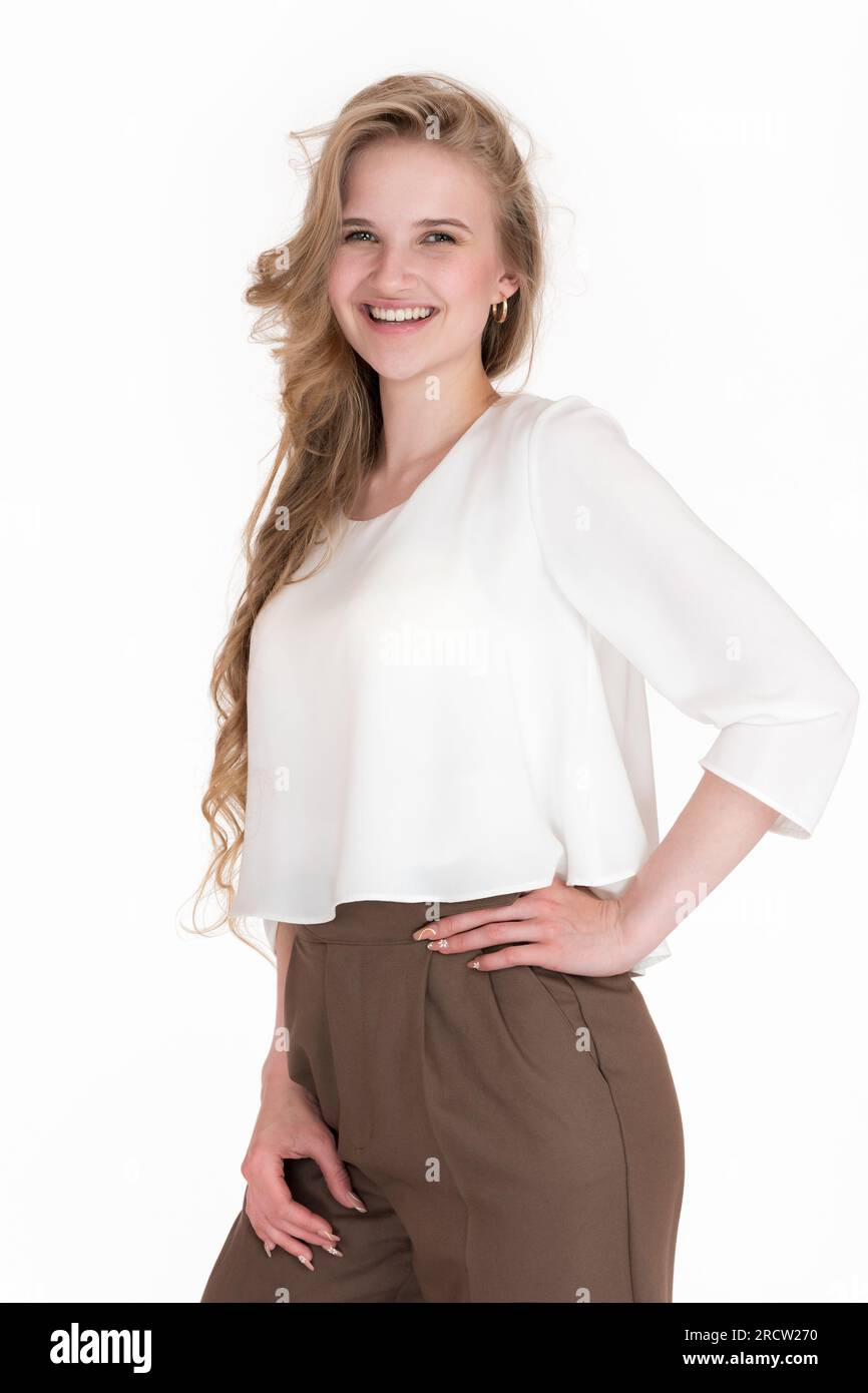 Happy young blonde woman with toothy smile and long hair looking at camera, posing on white background. Portrait of positive emotions European female Stock Photo
