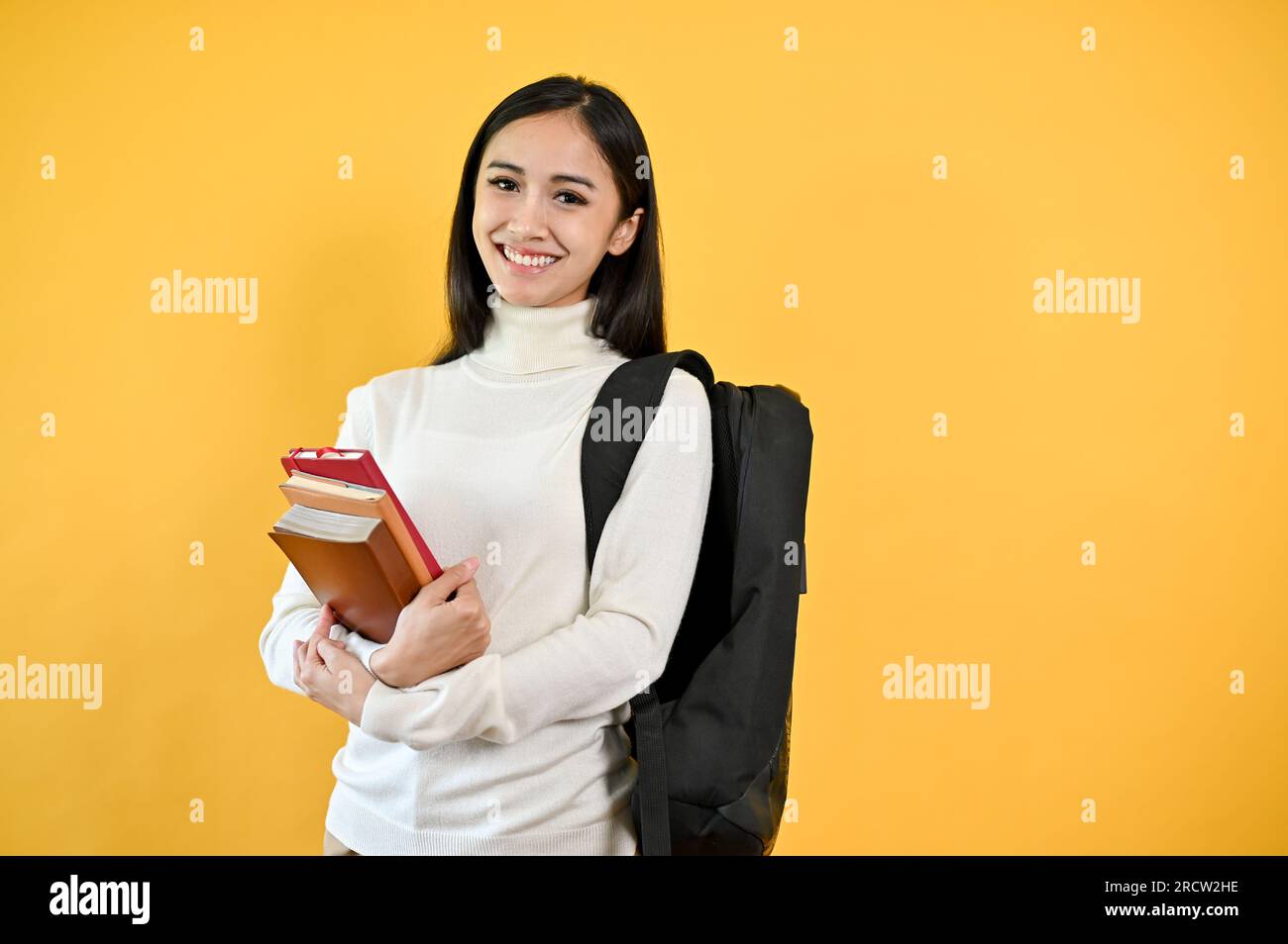 A portrait of a pretty young Asian female college student with her ...