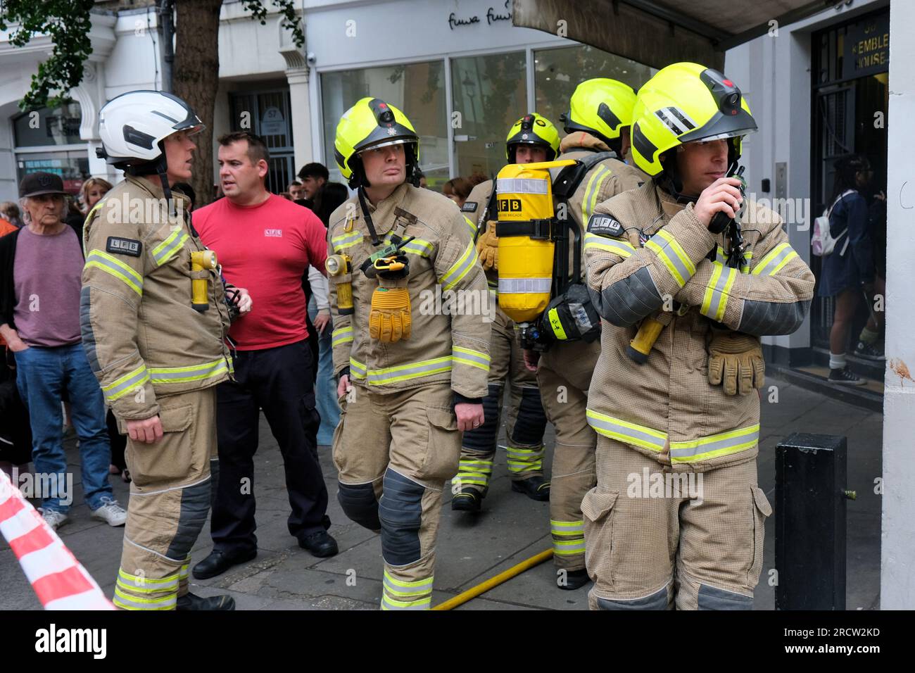 Firefighters in protective clothing outside the scene of a basement fire in London's Soho. Stock Photo