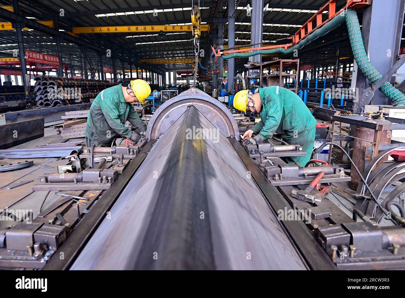 Two workers assemble equipment hi-res stock photography and images - Alamy