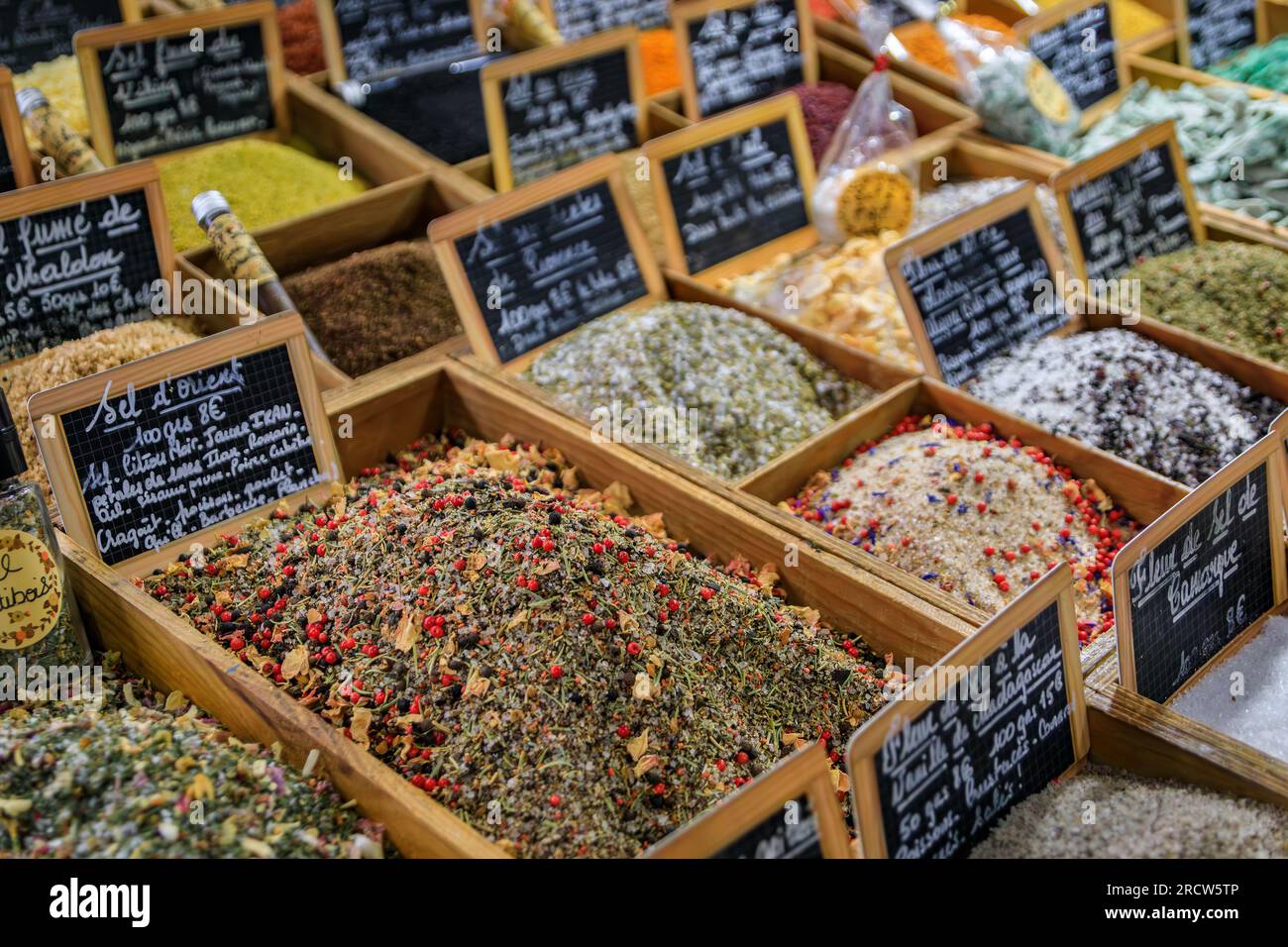 Exotic flavored salts with herbs and spices for sale at a local covered provencal farmers market hall in old town or Vieil Antibes, South of France Stock Photo