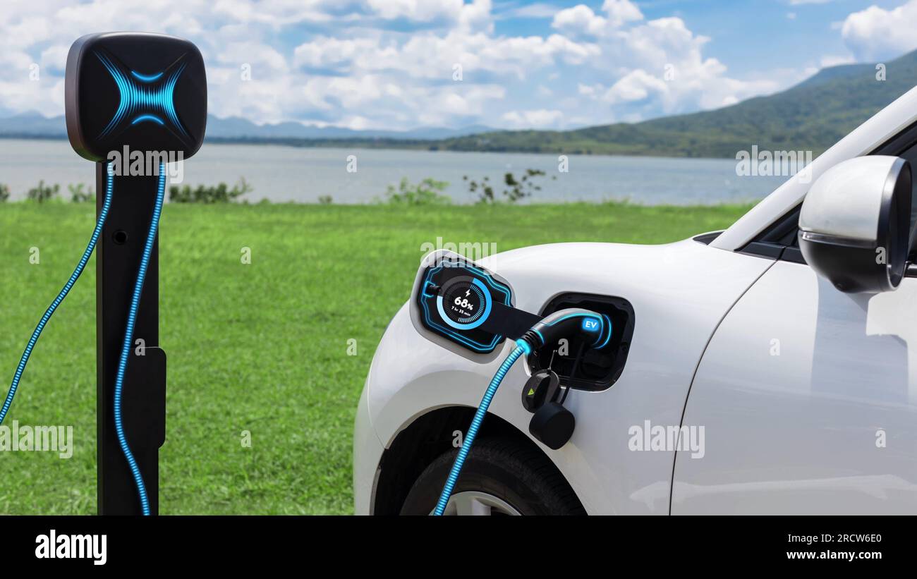 Electric car plugged in with charging station to recharge battery by EV