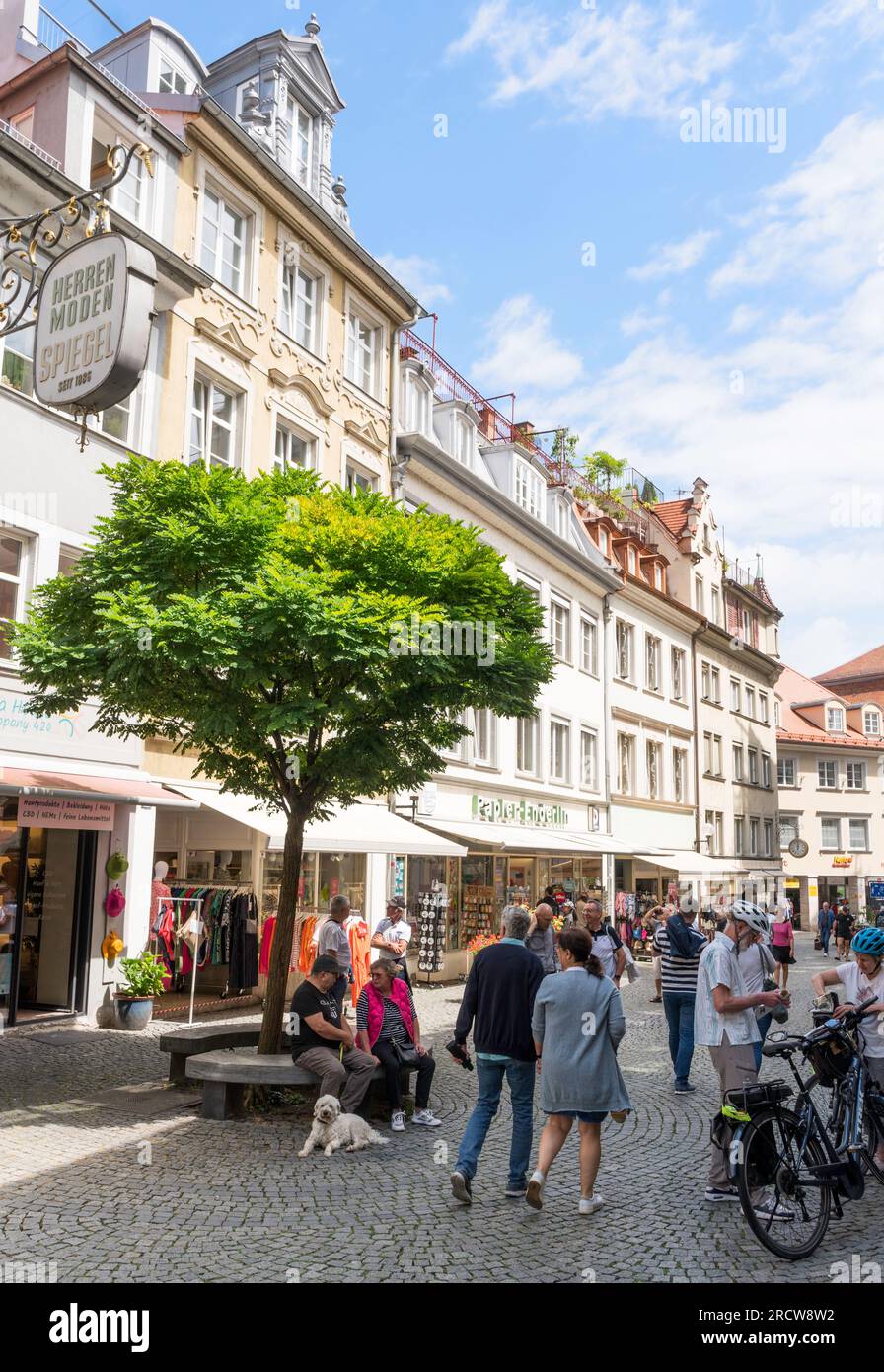 Couple walking in the town centre of Lindau, Bavaria, Germany Stock Photo