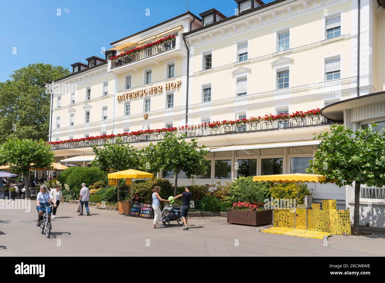People passing the Bayerischer Hof Hotel in Lindau, Bavaria, Germany Stock Photo