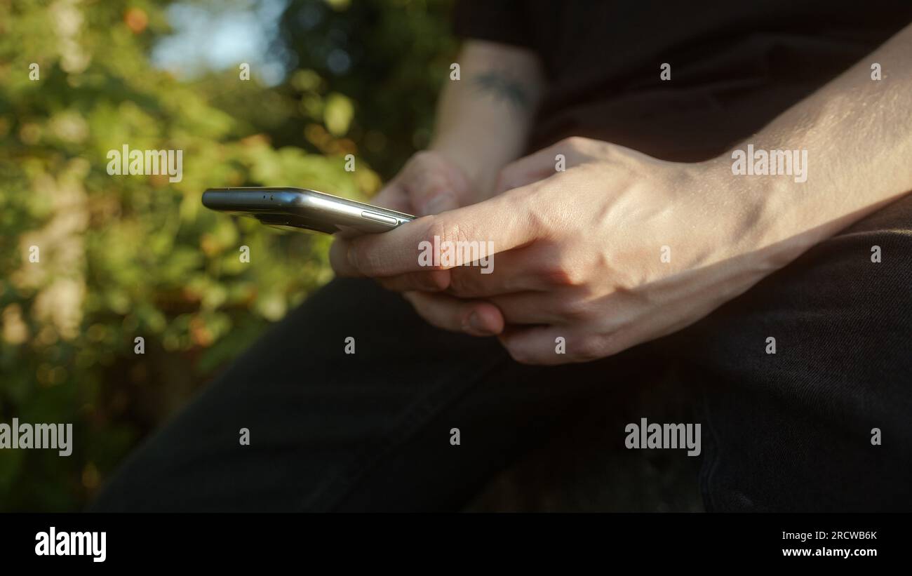 Seamless Connectivity: Close-Up of Smartphone Usage Outdoors, Emphasizing the Smart Device Stock Photo