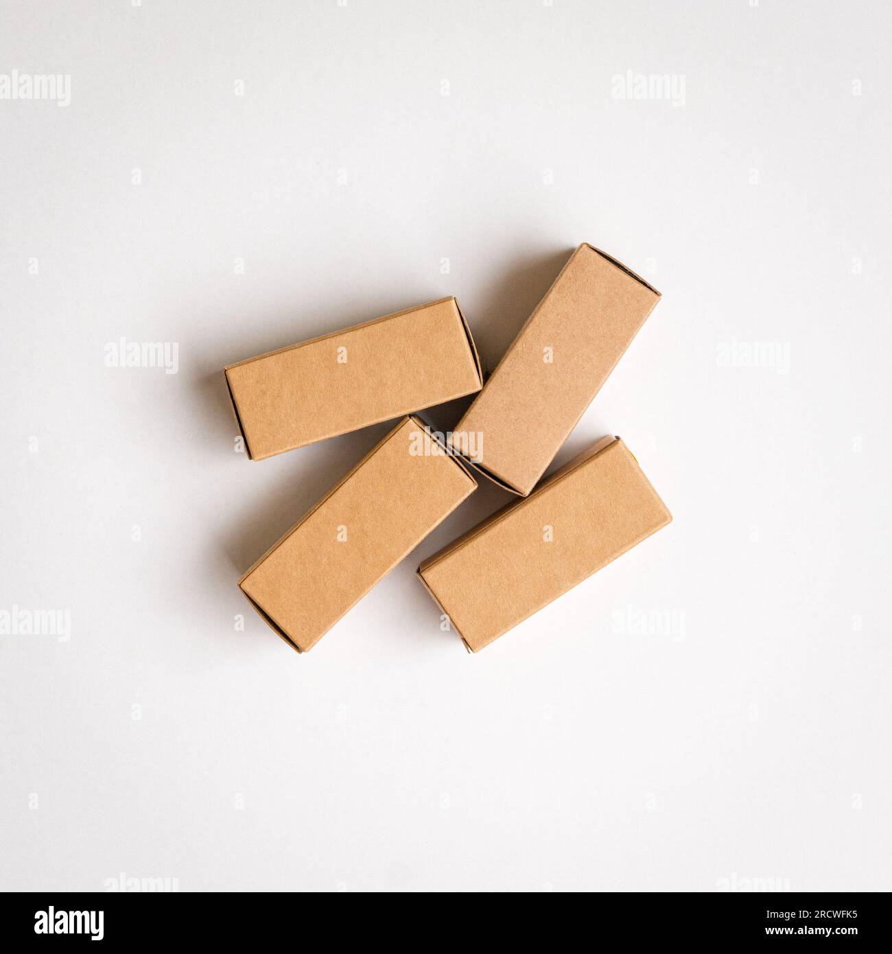 Four brown cardboard boxes with shadow. Top view, copy space. Stock Photo