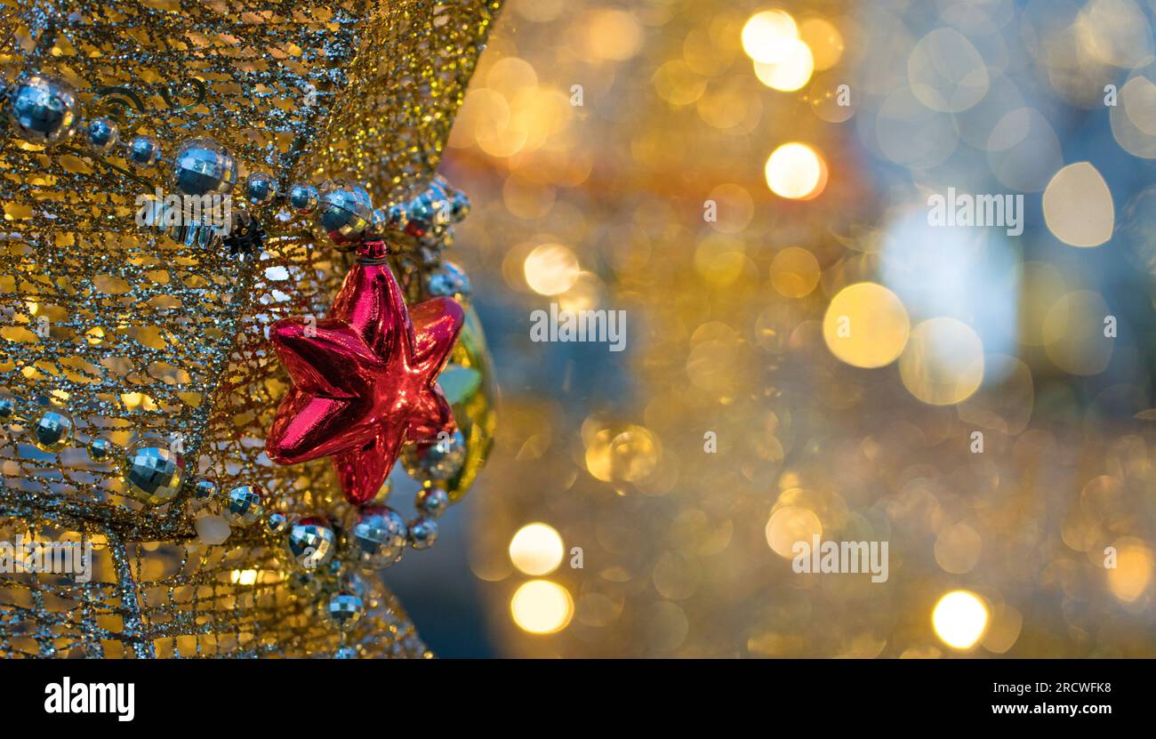 Hanging red star with light bokeh background. Copy space. Stock Photo