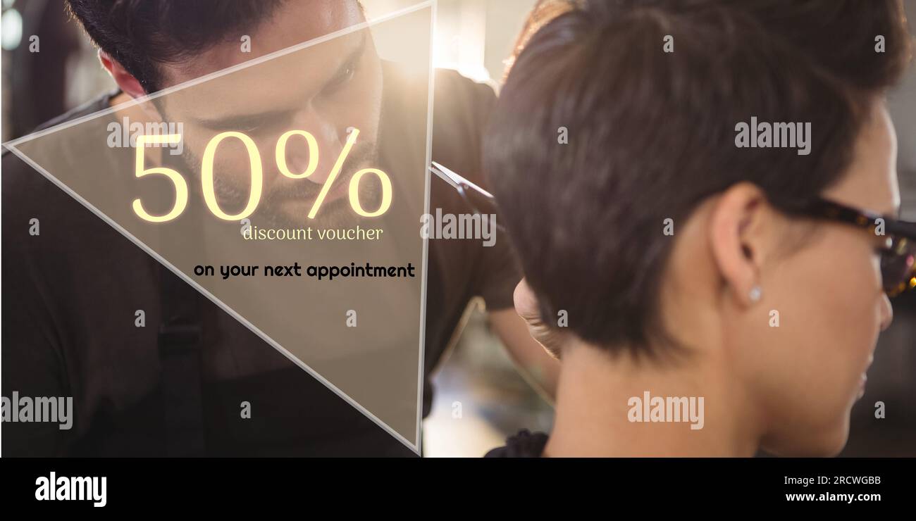 50 percent discount text with diverse female client and male hairdresser cutting hair Stock Photo