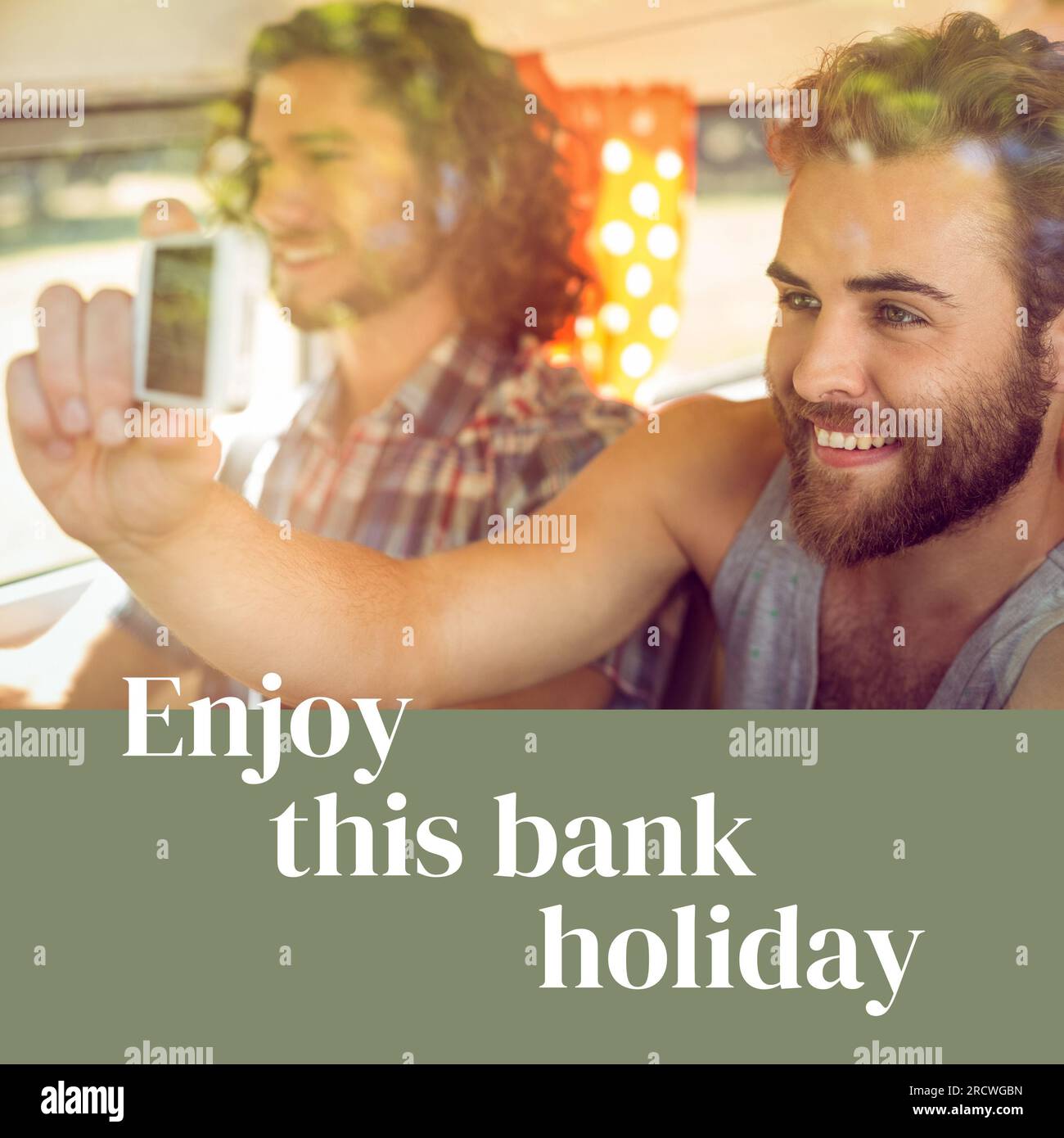 Enjoy this bank holiday text on grey with happy caucasian male friends on sunny trip taking photo Stock Photo