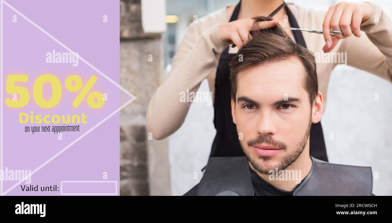 50 percent discount text with happy caucasian male client and female hairdresser cutting hair Stock Photo